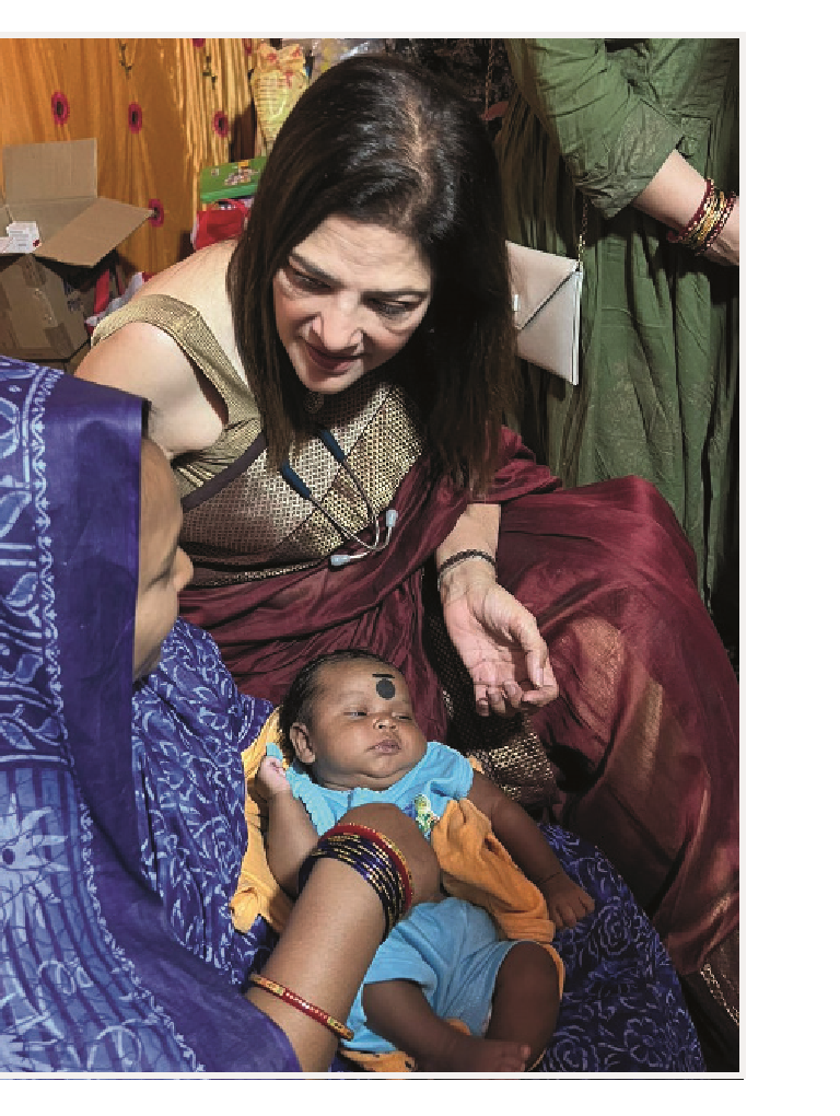 Dr. Indu Khosla with a mother and newborn